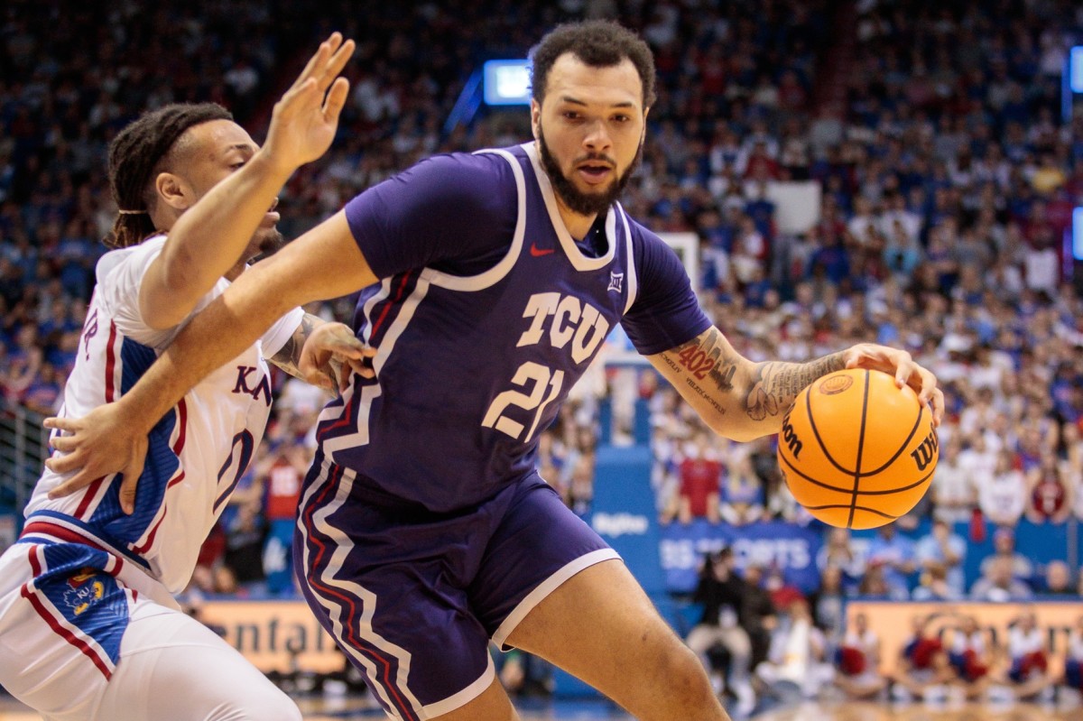 TCU Horned Frogs forward JaKobe Coles (21) drives around Kansas Jayhawks guard Bobby Pettiford Jr. (0) during the first half at Allen Fieldhouse.